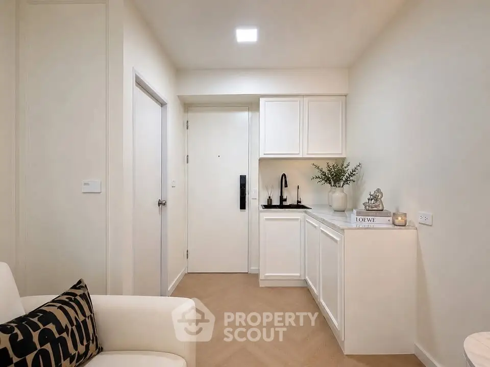 Chic modern entryway with white cabinetry and elegant decor