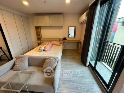Modern bedroom with balcony access and stylish decor in urban apartment