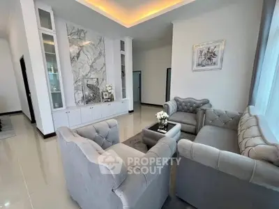 Elegant living room with plush gray sofas and marble accent wall