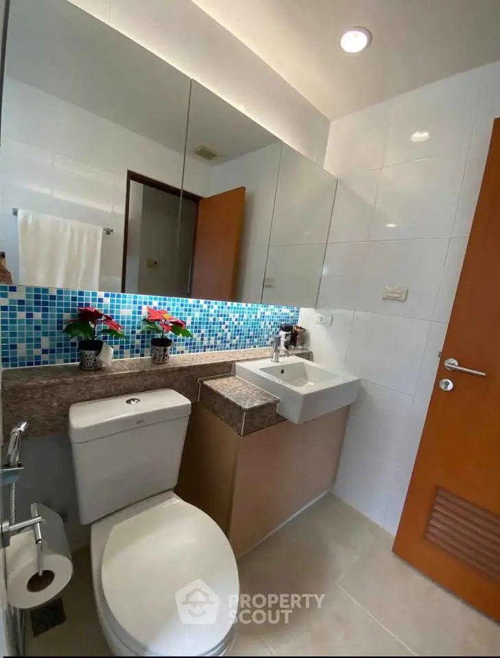 Modern bathroom with stylish mosaic tiles and sleek fixtures