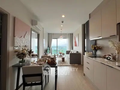 Modern open-plan living room with dining area and stunning city view.