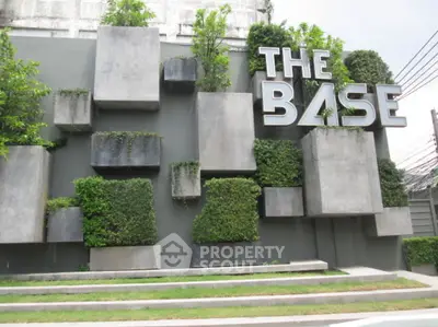 Modern architectural facade with greenery at The Base, showcasing unique urban design elements.