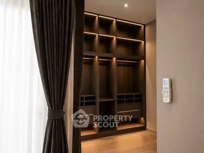 Luxurious walk-in closet with elegant lighting and ample storage space