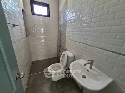 Modern bathroom with white subway tiles and sleek fixtures