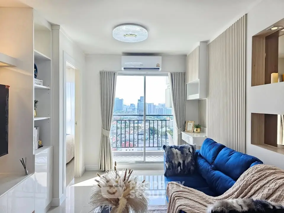Modern living room with blue sofa and city view balcony, bright and stylish interior design.