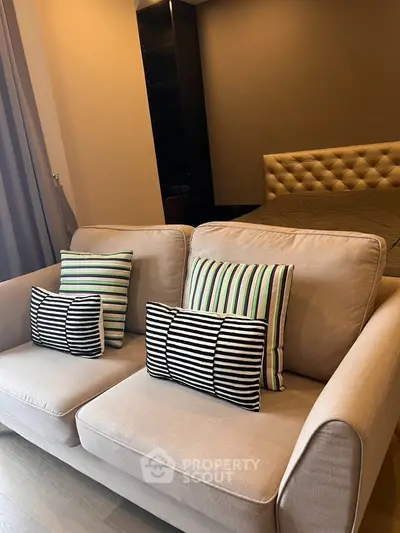 Cozy bedroom with stylish sofa and modern decor, perfect for relaxation and comfort.