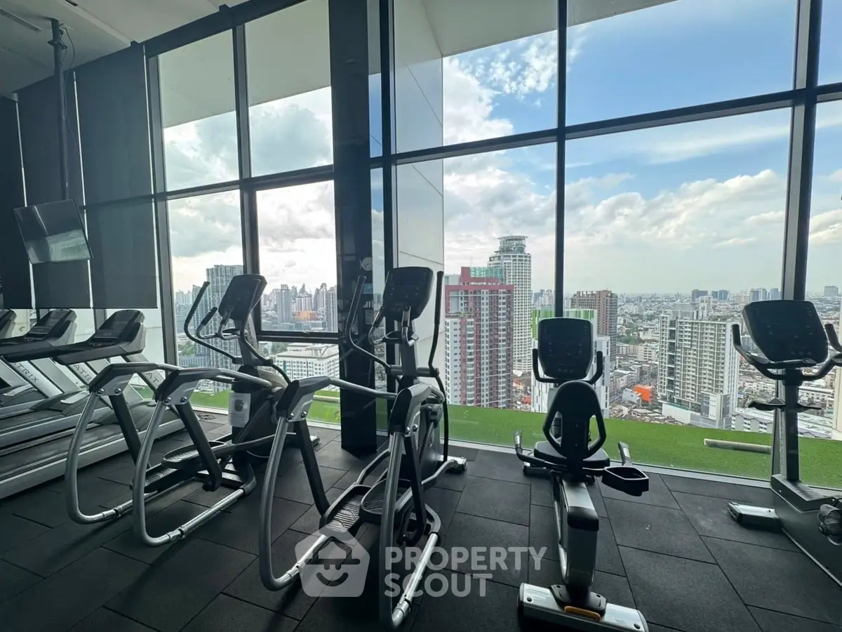 Modern gym with city view and state-of-the-art exercise equipment.