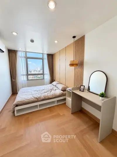 Modern bedroom with large window and stylish decor in urban apartment