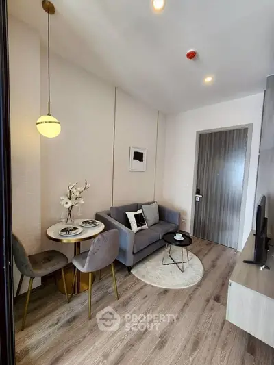 Modern living room with cozy seating and stylish decor in a contemporary apartment.