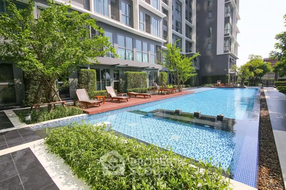 Luxurious apartment complex with stunning pool and lush greenery, perfect for relaxation and leisure.