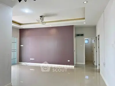 Spacious empty living room with modern ceiling fan and recessed lighting