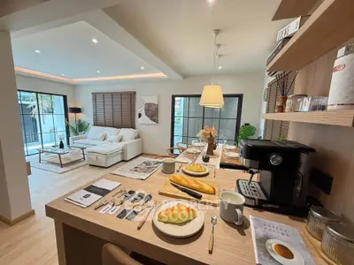 Modern open-plan kitchen and living room with stylish decor and natural light.