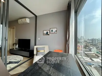 Modern apartment with city view, featuring stylish interior and large windows for natural light.