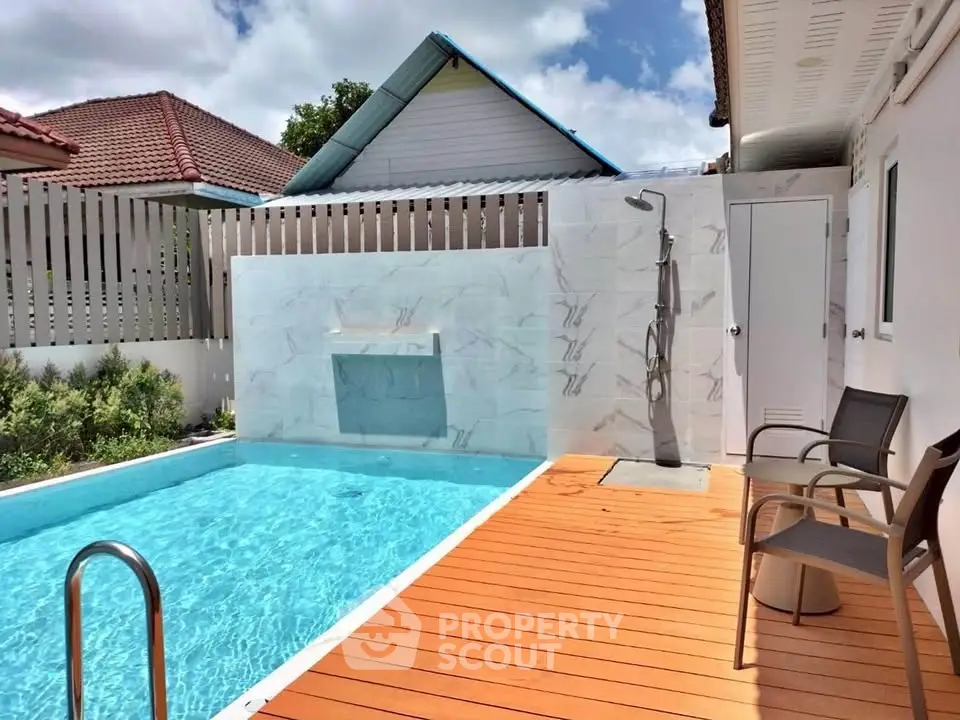 Charming backyard with private pool and outdoor shower, perfect for relaxation.