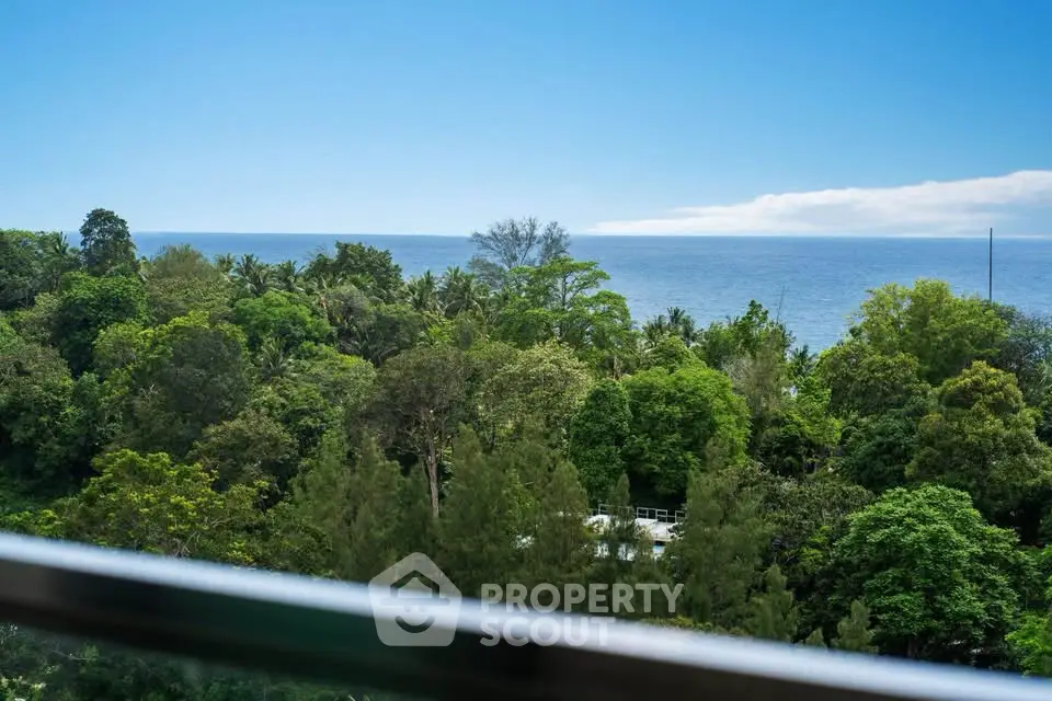 Stunning ocean view from a lush green balcony, perfect for relaxation and tranquility.