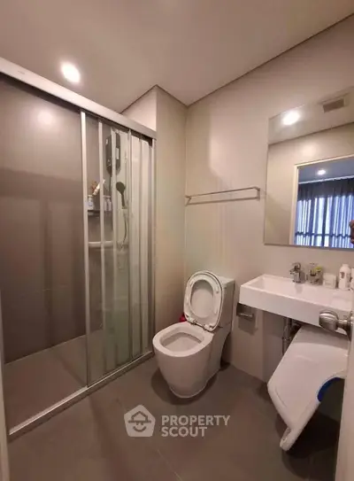Modern bathroom with sleek shower and contemporary fixtures in stylish apartment.