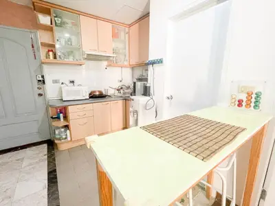 Charming kitchen with closed layout and modern appliances in cozy apartment.