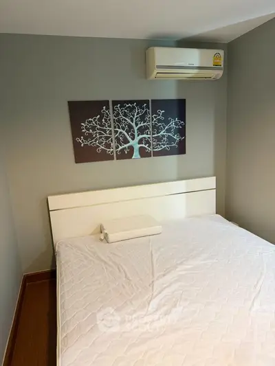 Cozy bedroom with modern decor and air conditioning, perfect for relaxation.