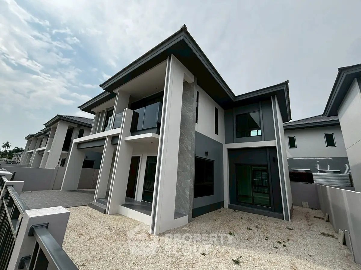 Modern two-story house with sleek design and spacious exterior in a serene neighborhood.