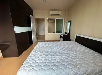 Spacious bedroom with modern furniture and air conditioning in a stylish apartment.