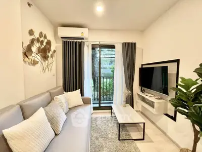 Modern living room with cozy sofa, wall-mounted TV, and garden view through large window.