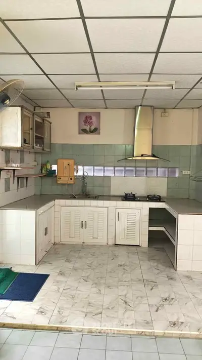 Spacious kitchen with tiled flooring and modern gas stove, perfect for culinary enthusiasts.