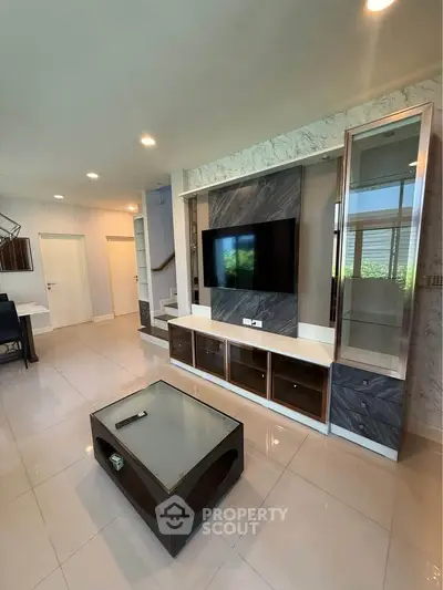 Modern living room with sleek TV unit and stylish coffee table, perfect for contemporary living.