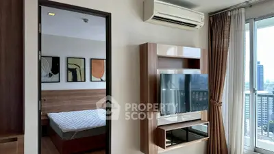 Modern bedroom with TV and air conditioning, featuring city view from balcony.