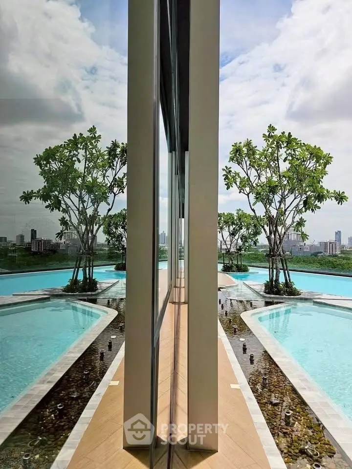 Luxurious rooftop pool with stunning city skyline view and lush greenery, perfect for relaxation and leisure.