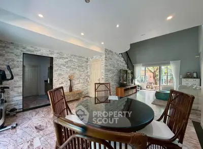 Spacious living room with modern decor and large windows offering natural light.