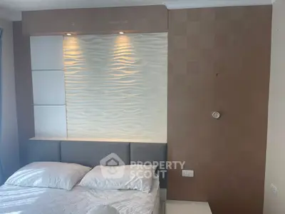 Modern bedroom with stylish wall paneling and cozy lighting