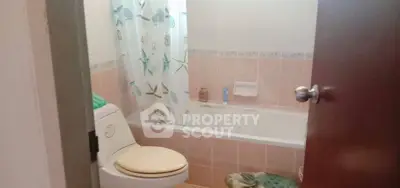 Cozy bathroom with bathtub and decorative shower curtain in a real estate property.