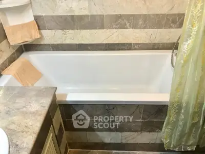 Elegant bathroom with modern bathtub and stylish tile design