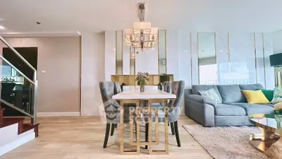 Luxurious open-plan living room with elegant dining area and plush seating, perfect for modern living.