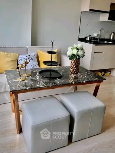 Stylish modern living room with marble table and cozy seating in a chic apartment.