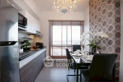Modern kitchen with sleek appliances and stylish dining area, featuring elegant decor and natural light.