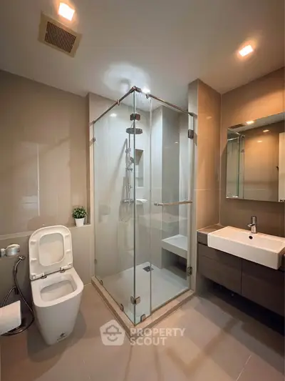 Modern bathroom with glass shower and sleek fixtures