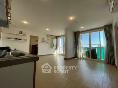 Spacious modern living room with large windows and balcony access