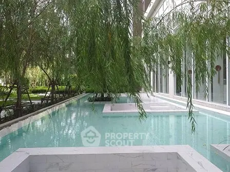 Luxurious poolside view with lush greenery and modern architecture