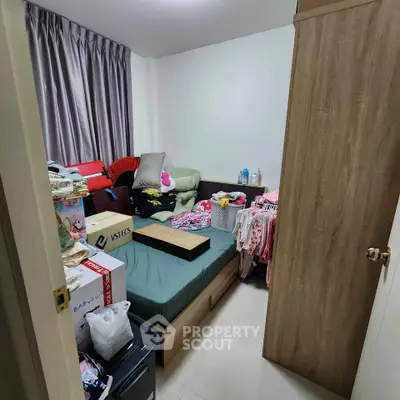 Cozy bedroom with ample storage and natural light, ideal for urban living.