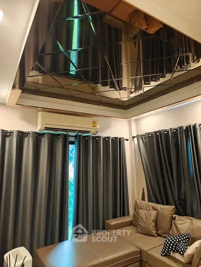 Modern living room with mirrored ceiling and stylish curtains