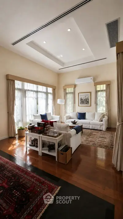 Spacious living room with elegant decor and large windows for natural light