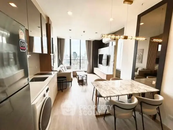 Modern open-layout living room with kitchen, featuring city view and stylish decor.