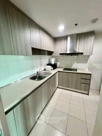 Modern kitchen with sleek cabinetry and built-in appliances in a stylish apartment.