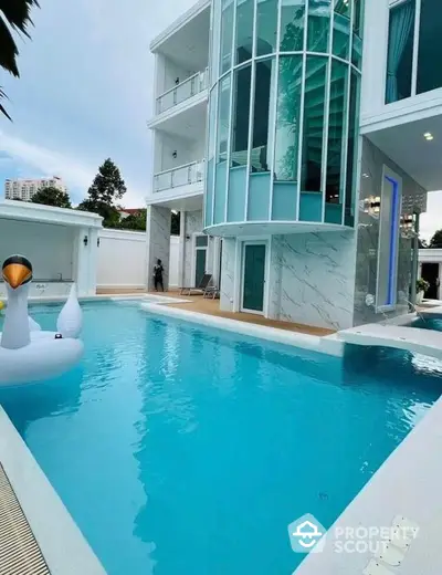 Luxurious modern villa with stunning pool and sleek glass architecture, perfect for upscale living and entertaining.