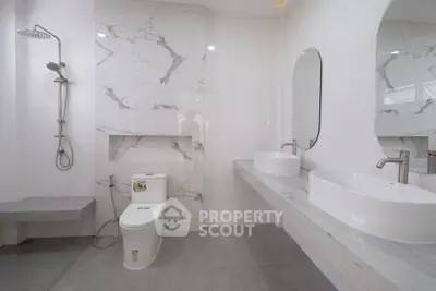 Luxurious modern bathroom with dual sinks and elegant marble accents.