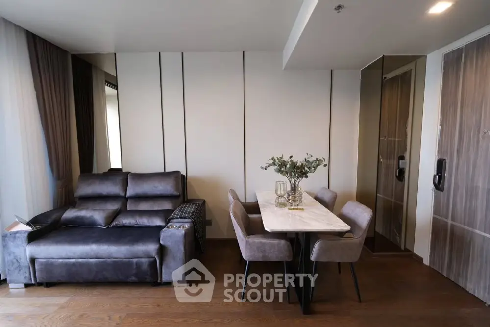 Modern living room with sleek furniture and dining area in elegant apartment