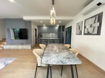 Modern open-plan living and dining area with stylish decor and natural light.