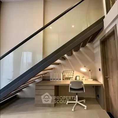 Modern study area under staircase with sleek desk and chair
