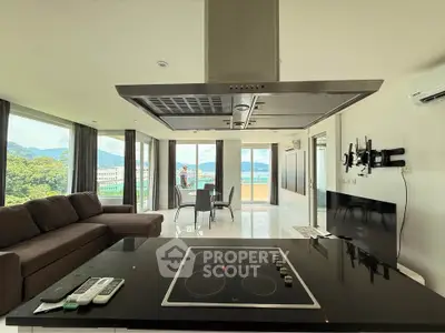 Spacious modern living room with open kitchen and stunning sea view